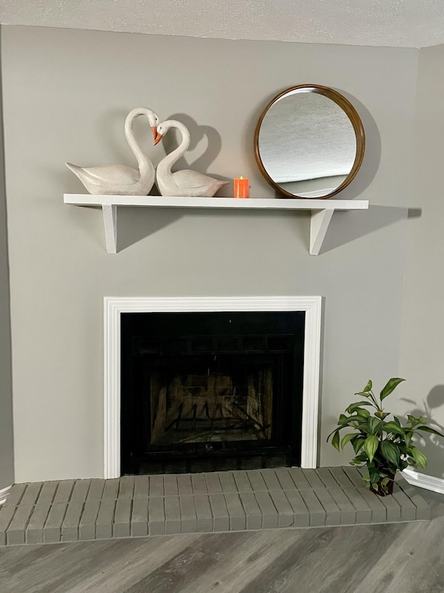 details featuring hardwood / wood-style flooring and a textured ceiling