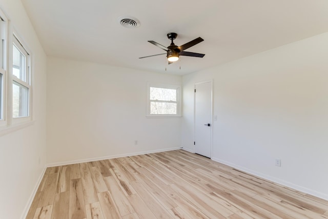 spare room with ceiling fan and light wood-type flooring