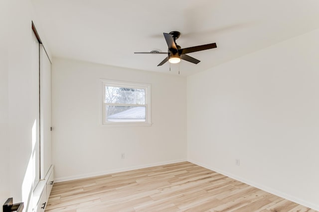 unfurnished room with ceiling fan and light wood-type flooring