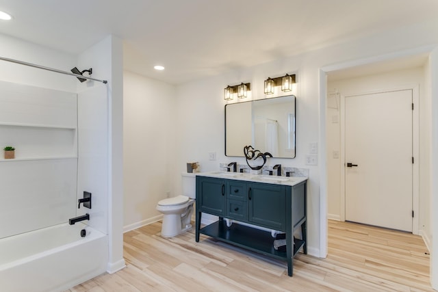 full bathroom with shower / tub combination, wood-type flooring, toilet, and vanity