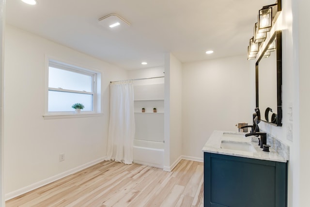 bathroom featuring vanity, hardwood / wood-style floors, and shower / bath combo with shower curtain