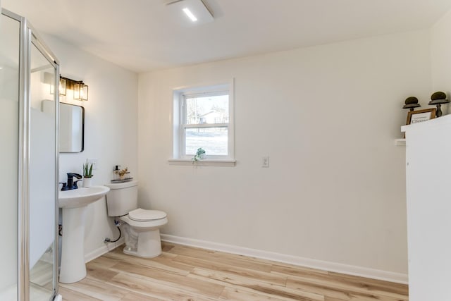 bathroom with wood-type flooring, sink, and toilet