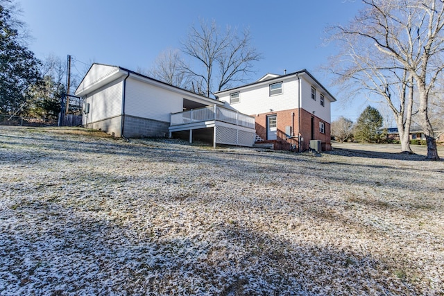 back of property with a wooden deck and central AC unit