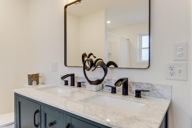 bathroom with walk in shower and vanity