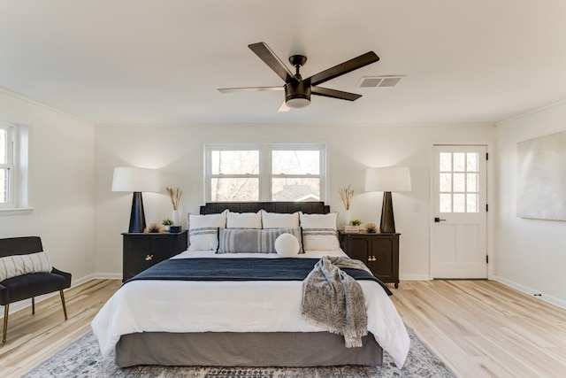 bedroom featuring crown molding, ceiling fan, and light wood-type flooring