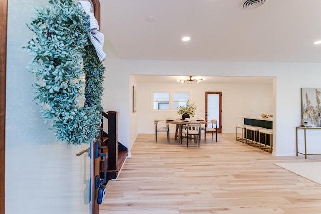 dining room featuring an inviting chandelier and light wood-type flooring