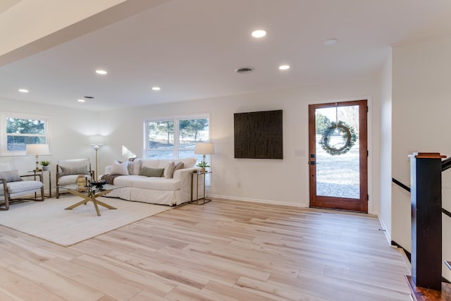 living room featuring light hardwood / wood-style flooring and a healthy amount of sunlight