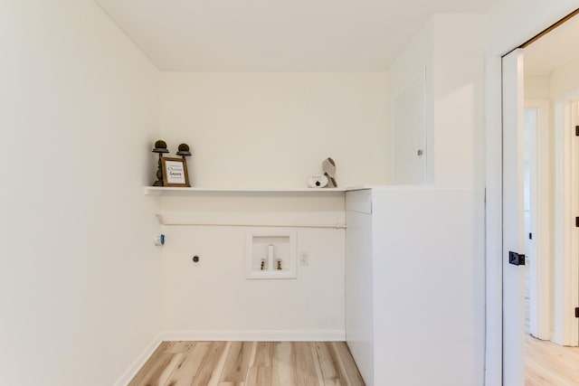 laundry area with hookup for an electric dryer, hookup for a washing machine, and light hardwood / wood-style flooring