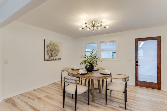 dining area with a notable chandelier and light wood-type flooring