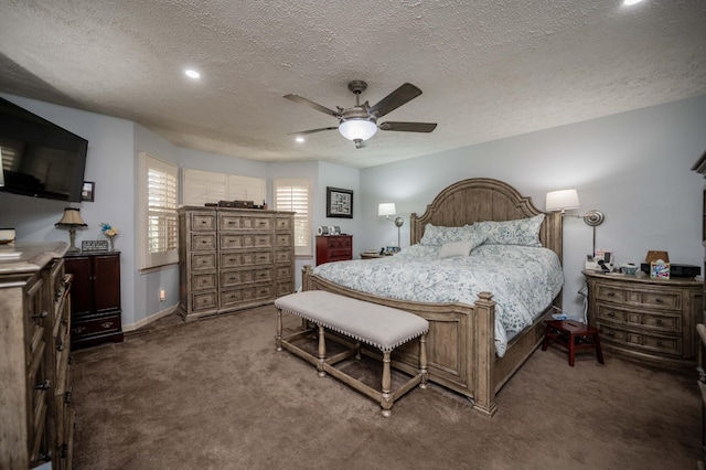 bedroom featuring ceiling fan, dark carpet, and a textured ceiling