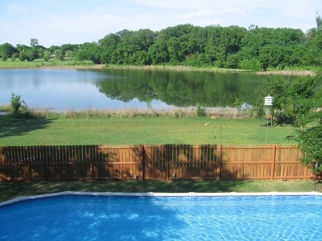 view of swimming pool with a water view