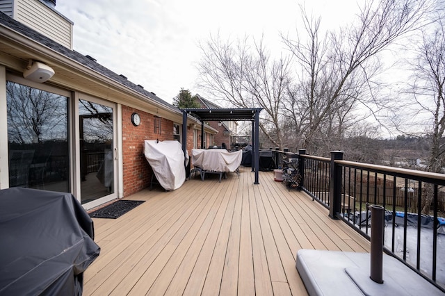 wooden deck with a grill