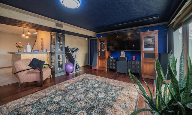 interior space featuring crown molding, dark hardwood / wood-style floors, and a textured ceiling