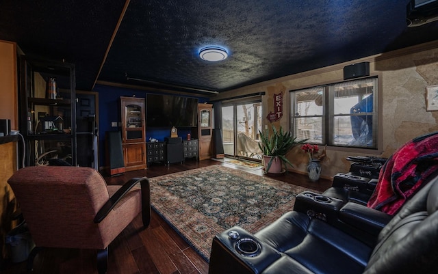 living room featuring crown molding, dark wood-type flooring, and a textured ceiling