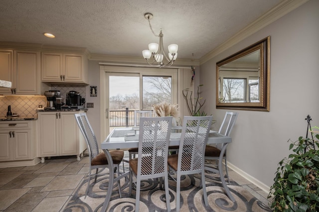 dining room with ornamental molding, a notable chandelier, and a textured ceiling