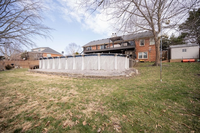 view of yard featuring a storage unit and an empty pool