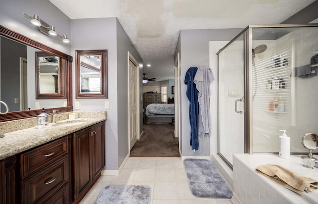 bathroom with ceiling fan, tile patterned flooring, vanity, a textured ceiling, and a shower with shower door