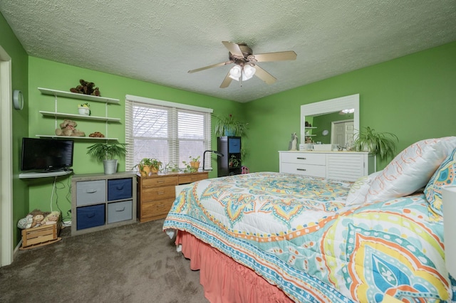 bedroom with ceiling fan, a textured ceiling, and dark carpet