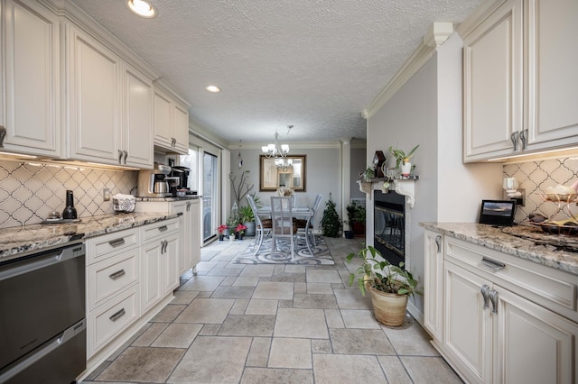 kitchen featuring decorative light fixtures, stainless steel dishwasher, and white cabinets