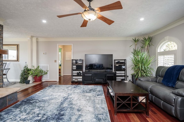 living room featuring ceiling fan, crown molding, dark hardwood / wood-style floors, and a textured ceiling