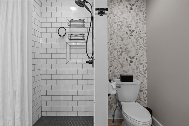 bathroom with tiled shower and toilet