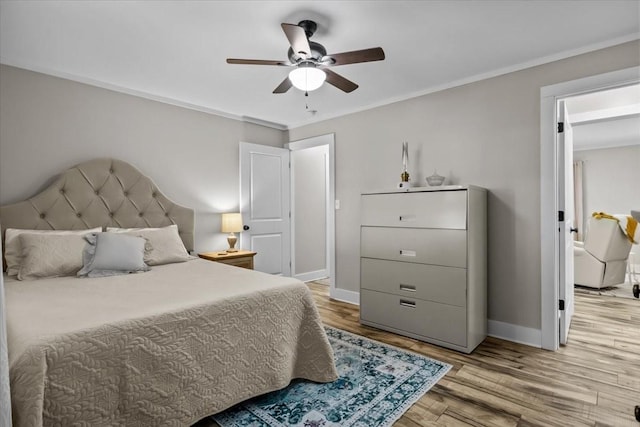 bedroom featuring crown molding, light hardwood / wood-style floors, and ceiling fan