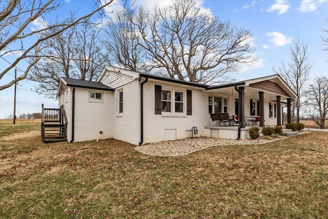 view of home's exterior featuring covered porch and a lawn