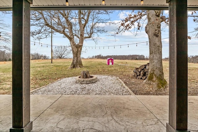 view of patio / terrace with a rural view and a fire pit