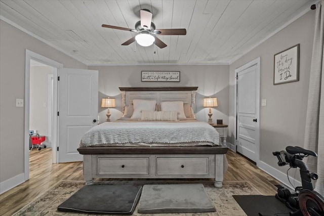 bedroom with hardwood / wood-style flooring, ceiling fan, ornamental molding, and wooden ceiling