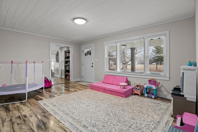 recreation room featuring ornamental molding, hardwood / wood-style floors, and wooden ceiling