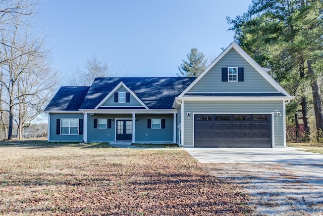 view of front of house with a garage and a front lawn