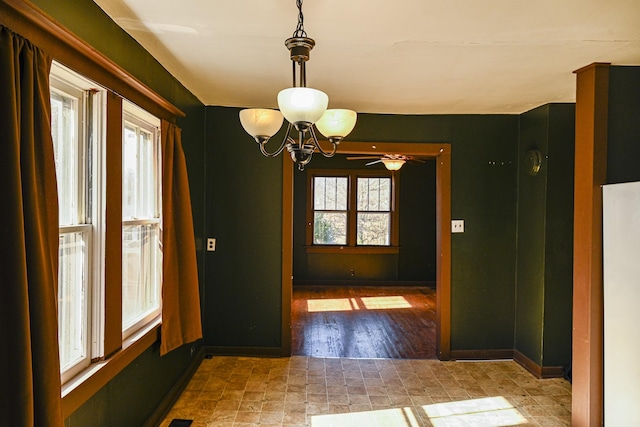 unfurnished dining area with a chandelier