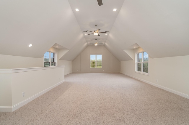 bonus room featuring lofted ceiling, light colored carpet, and ceiling fan