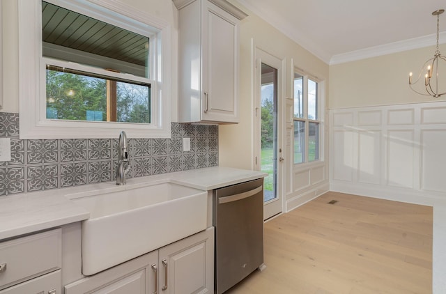 kitchen featuring sink, crown molding, backsplash, stainless steel dishwasher, and light wood-type flooring