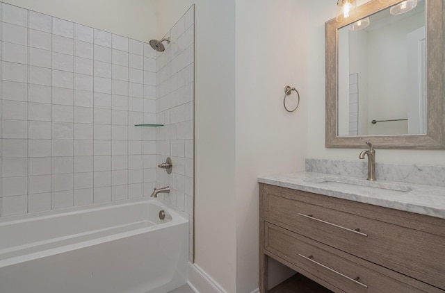 bathroom featuring tiled shower / bath combo and vanity