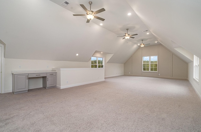 additional living space with lofted ceiling and light colored carpet