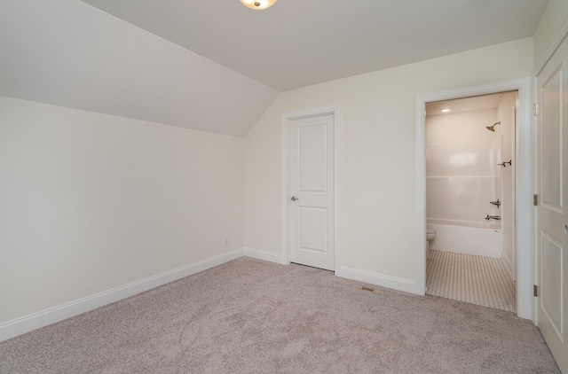 bonus room featuring light carpet and lofted ceiling