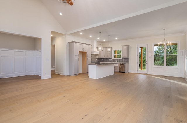 kitchen with stainless steel dishwasher, decorative light fixtures, a center island, and a notable chandelier