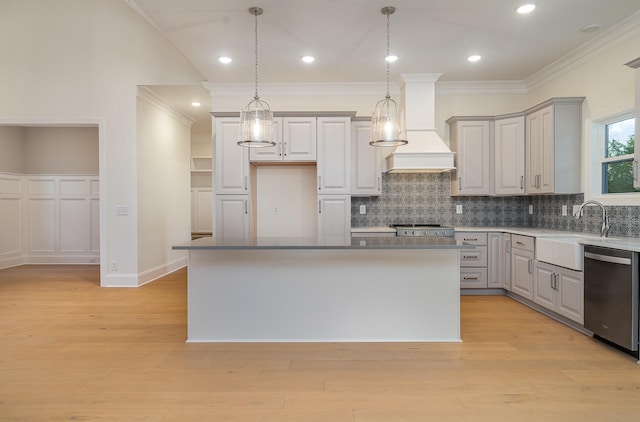 kitchen featuring a center island, dishwasher, and sink