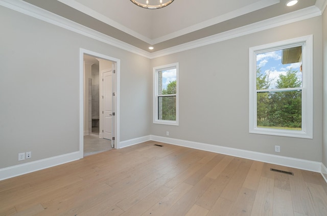 unfurnished room with crown molding and light hardwood / wood-style floors