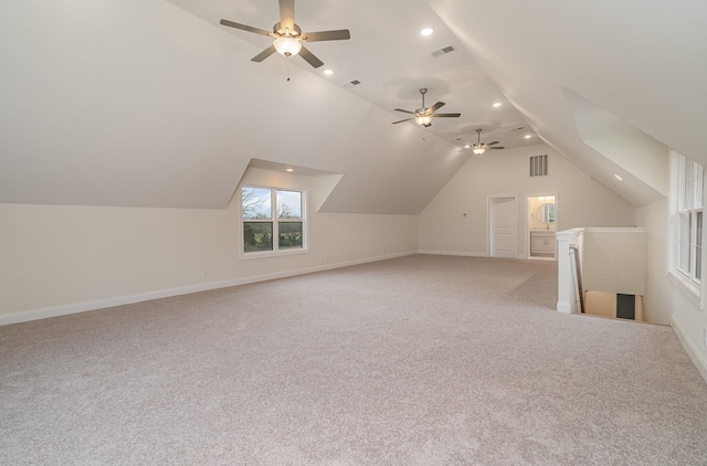 additional living space with lofted ceiling and light carpet