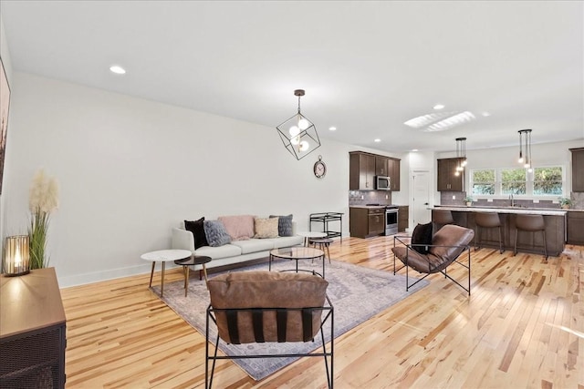 living room featuring light hardwood / wood-style floors and sink