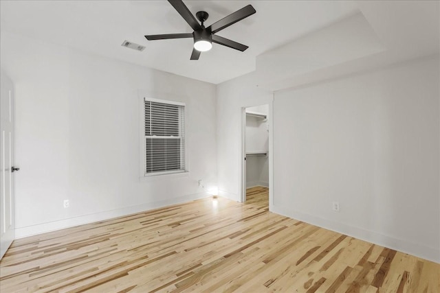 empty room featuring ceiling fan and light wood-type flooring