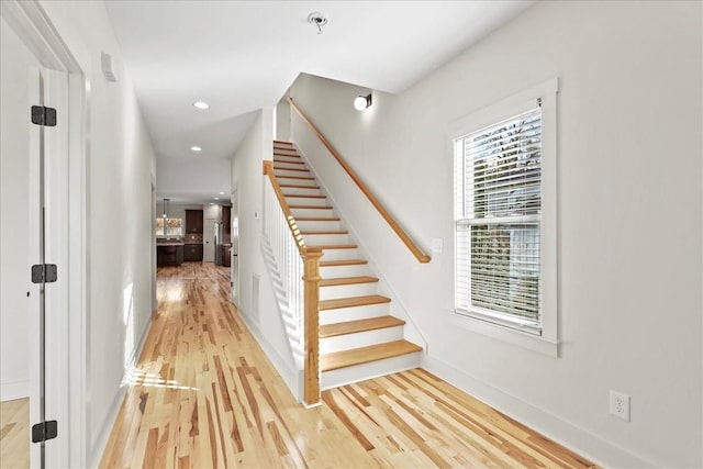 staircase with hardwood / wood-style floors