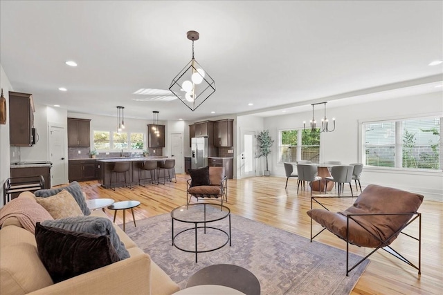 living room featuring a wealth of natural light and light wood-type flooring