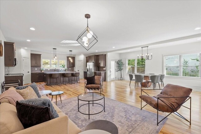 living room featuring plenty of natural light and light hardwood / wood-style floors