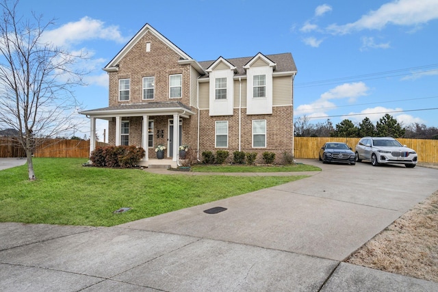 view of front of property with a front yard and covered porch