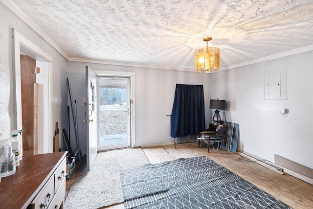 entryway featuring crown molding, a textured ceiling, electric panel, and an inviting chandelier