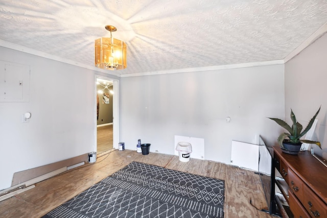 interior space featuring hardwood / wood-style floors, a notable chandelier, ornamental molding, and a textured ceiling