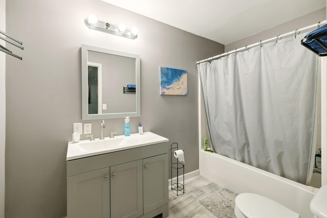 full bathroom featuring vanity, shower / bath combination with curtain, and toilet